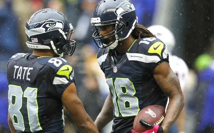 NFL players on the field displaying sporting gestures.