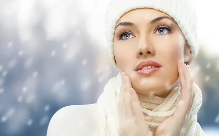 A brunette at the side of the image looking into the distance.