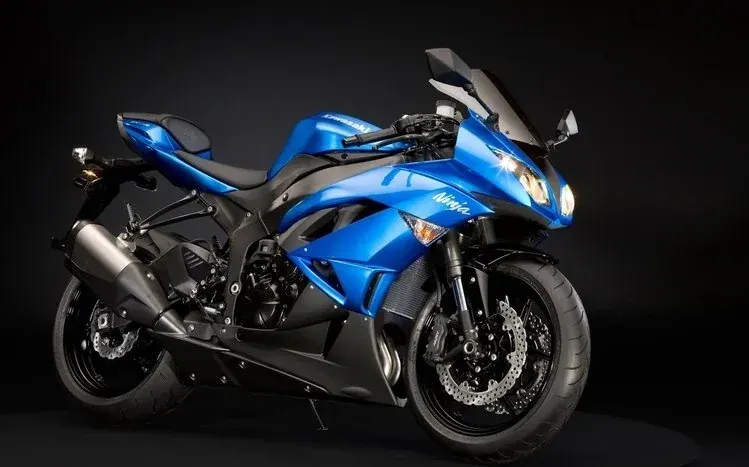 Kawasaki Ninja sports bikes in different colors, with and without riders.