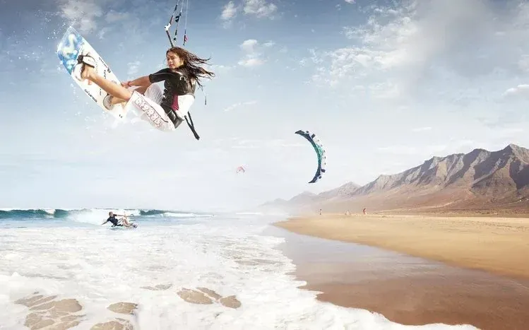 Kitesurfing wallpaper imagery combining surfing and kites outdoors.