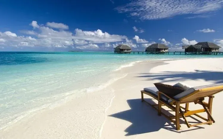 Maldives scenery with blue waters, sandy beaches, and overwater bungalows.