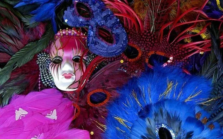 Colorful Mardi Gras masks, ornaments, and jewelry in varied decorative designs.
