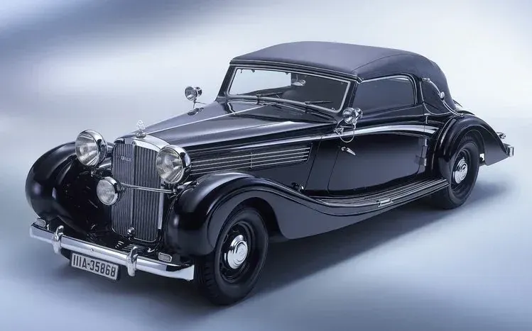 Maybach cars pictured in front of houses and in garages.