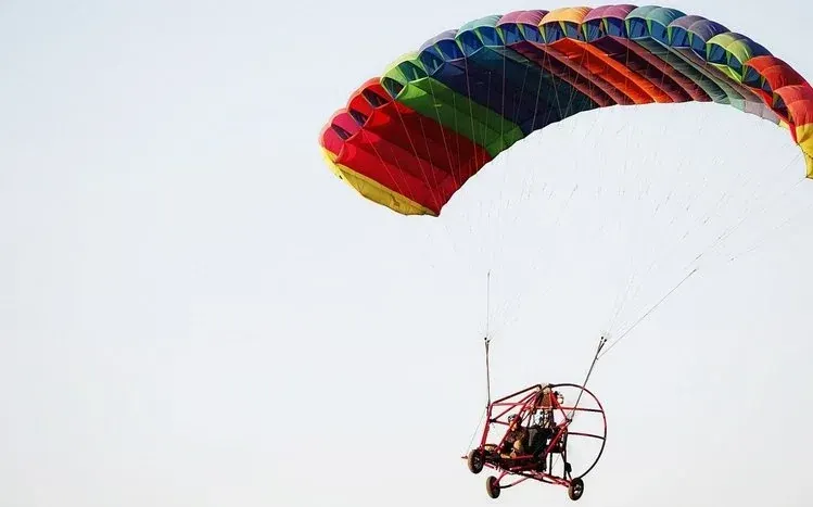Paragliding-themed images featuring flight over scenic landscapes.