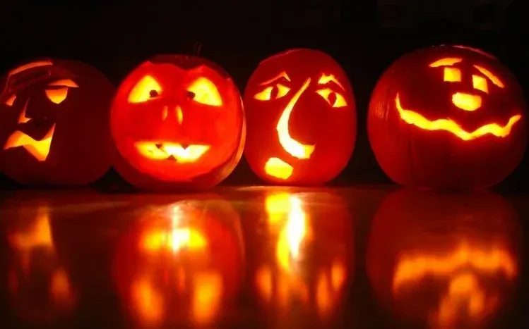 Festive Halloween pumpkin imagery with surrounding lights.