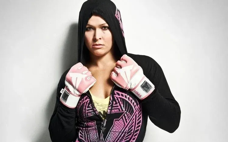 Ronda Rousey wallpapers featuring mat grappling, cage appearances, and focused expressions.