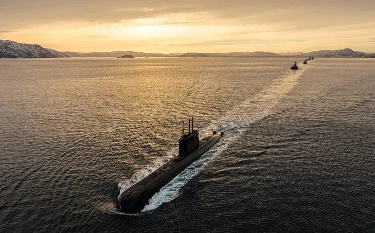 Submarines viewed from different angles at the surface and beginning to submerge.