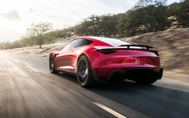 Tesla Roadster wallpapers featuring a red sports car.