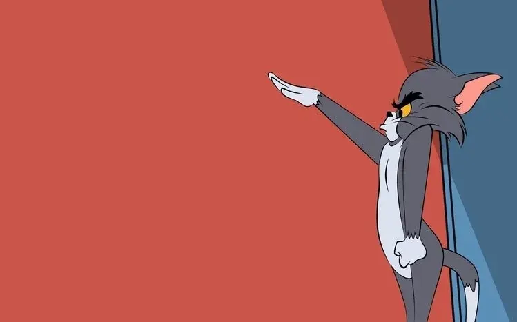 Tom chasing a smiling Jerry in space, with Martians riding flying saucers behind them.