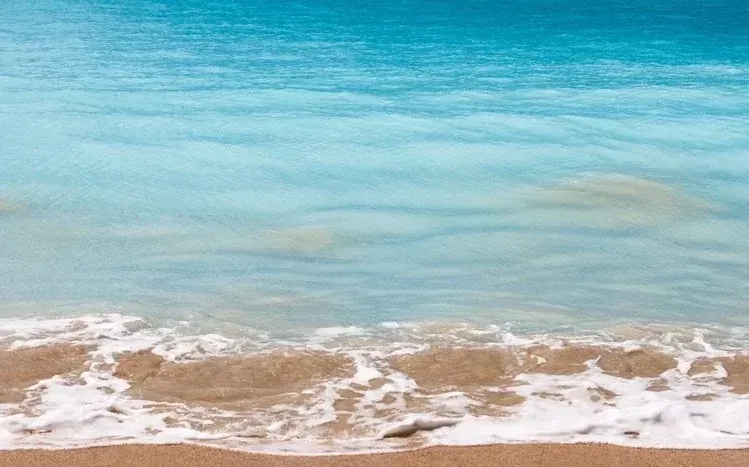 Sea waves in varied scenes and magnitudes for a dual-monitor wallpaper collection.