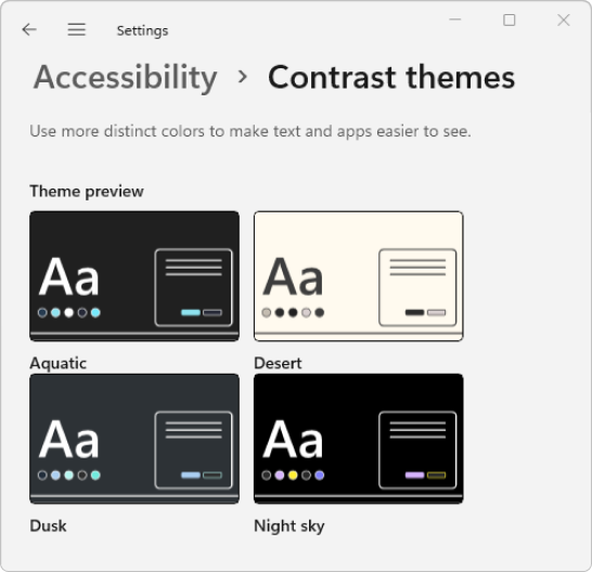 Microsoft Windows Settings contrast-theme preview showing Aquatic, Desert, Dusk and Night sky in a two-by-two grid.