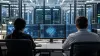 Cybersecurity professionals monitor advanced AI systems in a secure data-center operations room.