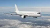 Unbranded passenger aircraft cruising above layered clouds in neutral daylight