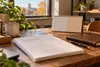 Conceptual editorial image of business renewal paperwork, a calendar and a ledger on an office desk