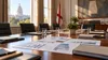 A neutral Alabama government meeting room prepared for a policy discussion