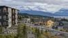 Alaska apartment buildings and new homes beneath distant mountains