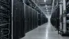 Rows of AI server racks and accelerator hardware in a modern data center under natural industrial lighting