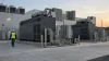 Industrial backup generators and electrical infrastructure outside a modern data center at sunrise