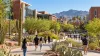 Students walking through a desert-landscaped public university campus in Arizona beneath clear morning skies.
