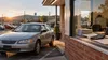 A modest used sedan parked outside a small-town consumer finance office in Arkansas.