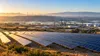 California solar arrays, wind turbines and industrial infrastructure in clear morning light