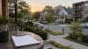 Blank clipboard on a porch overlooking a residential neighborhood at dawn