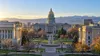Illustrative view of the Colorado State Capitol and surrounding civic buildings in early morning light.