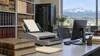 A document scanner, archival record books and a secure computer station in a Colorado county records office.