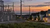 Electric utility lines and a substation serving Delaware homes at dusk.
