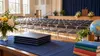 Illustrative empty school auditorium set for graduation with plain diploma folders and unbranded learning materials.