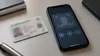 Illustrative smartphone identity-verification screen beside a blurred government identification card