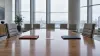 An unbranded diplomatic conference table with two document folders and empty chairs.