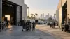 Production crews move camera equipment between two unbranded soundstages on a Los Angeles studio lot.