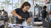 Adult student practicing advanced manufacturing skills in a modern technical-college workshop