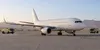 Illustrative view of an unbranded passenger aircraft on a desert airport apron after an emergency diversion