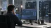 A cybersecurity analyst monitoring an isolated test workstation in an unbranded network operations center.