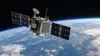 Unbranded experimental computing satellite in low Earth orbit above the curved Earth