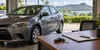Car keys and blank loan papers beside an unbranded vehicle in tropical daylight