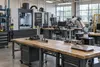 A modern community-college manufacturing lab with a CNC machine, robotic arm and workbenches.