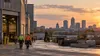 An Indiana industrial district and city skyline with anonymous workers in the foreground