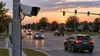 A roadside traffic-monitoring camera overlooks an Indiana intersection at dusk.