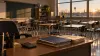 Empty Indiana classroom with desks, budget folders and a calculator in late-afternoon light
