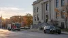 Generic police and fire vehicles outside a Midwestern civic building in autumn