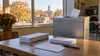 Unbranded ballot box and blank envelopes in an Iowa civic setting during autumn