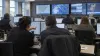 Emergency-management professionals coordinate at workstations in a generic operations center.