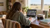 Illustration of a student attending an online class from a home desk overlooking a Kansas prairie.