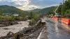 Illustration of flood-damaged roadside infrastructure under repair in the green hills of rural Kentucky.