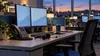 An empty behavioral-health crisis support workstation with telephone and headset in a calm call center at dusk.
