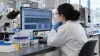 A molecular pathology scientist reviews genomic sequencing data in a hospital laboratory