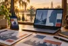 Laptop and smartphone displaying abstract political media graphics on a desk in warm Louisiana light